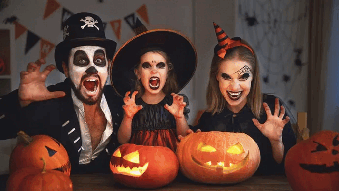 a family wearing costumes enjoying Halloween